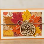 A handcrafted Thanksgiving greeting card adorned with fall leaves, pumpkins, and a heartfelt message.