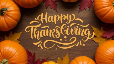 Elegant “Happy Thanksgiving” calligraphy with autumn leaves and warm seasonal colors on a festive background.