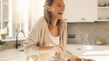 Happy Woman Cooking Healthy Meal Home Kitchen Lifestyle, bright and cheerful, culinary blog use, transparent background PNG.