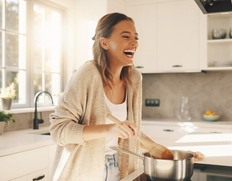 Happy Woman Cooking Healthy Meal Home Kitchen Lifestyle, bright and cheerful, culinary blog use, transparent background PNG.